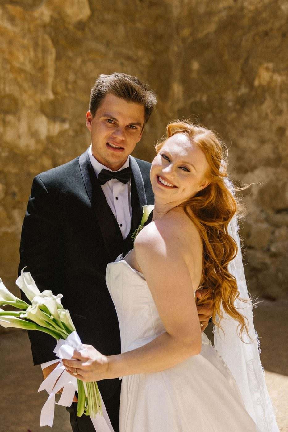 Bride and groom embracing, bridal makeup by Xander Tang at Franciscan Gardens, San Juan Capistrano